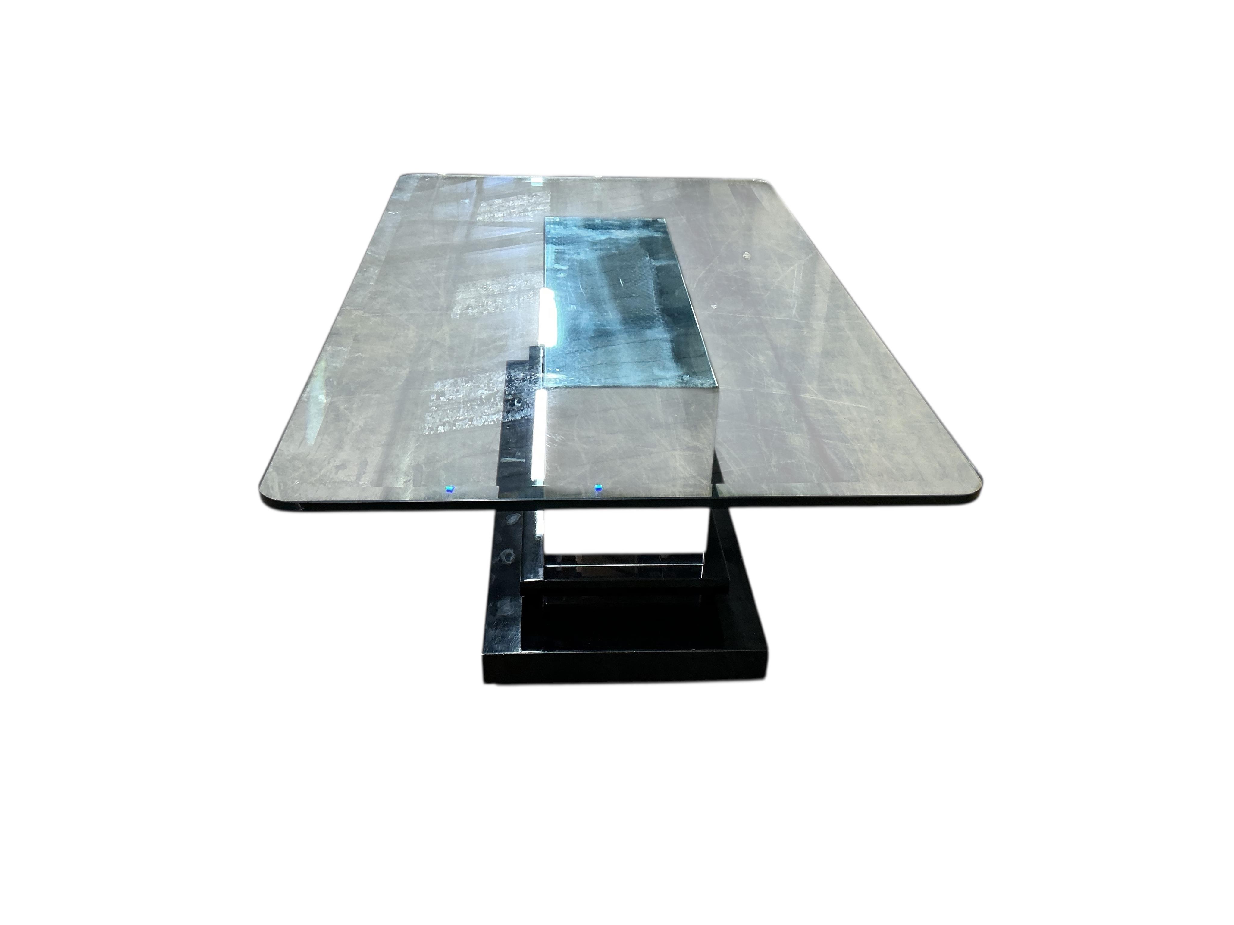 A Contemporary rectangular glass coffee table on mirrored, ebonized plinth base, width 140cm, depth 84cm, height 46cm